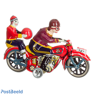 Motorcycle with passenger with ball
